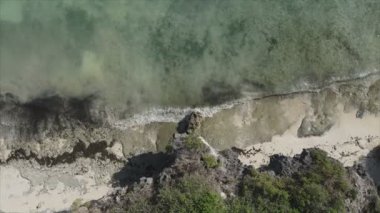 This stock video shows an aerial view of the ocean near the coast of Zanzibar, Tanzania, slow motionin in 8K resolution