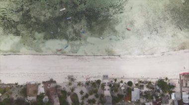 This stock video shows an aerial view of the ocean near the coast of Zanzibar, Tanzania, slow motionin in 8K resolution
