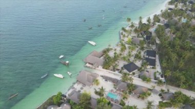 This stock video shows an aerial view of the ocean near the coast of Zanzibar, Tanzania, slow motionin in 8K resolution