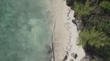 This stock video shows an aerial view of the ocean near the coast of Zanzibar, Tanzania, slow motionin in 8K resolution