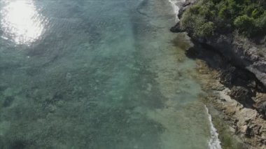 This stock video shows an aerial view of the ocean near the coast of Zanzibar, Tanzania, slow motionin in 8K resolution