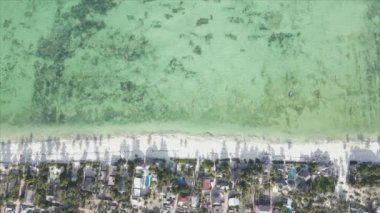 This stock video shows an aerial view of the ocean near the coast of Zanzibar, Tanzania, slow motionin in 8K resolution