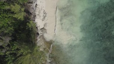 This stock video shows an aerial view of the ocean near the coast of Zanzibar, Tanzania, slow motionin in 8K resolution