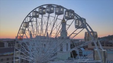 This stock video shows ferris wheel in the morning at sunrise in Kyiv, Ukraine in 8K resolution