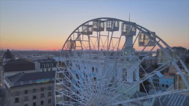 This stock video shows ferris wheel in the morning at sunrise in Kyiv, Ukraine in 8K resolution
