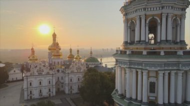 This stock video shows an aerial view of the Kyiv-Pechersk Lavra in the morning at sunrise, Ukraine in 8K resolution