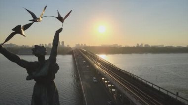 This stock footage shows aerial view of metro bridge in the morning at sunrise in Kyiv, Ukraine in 8K resolution
