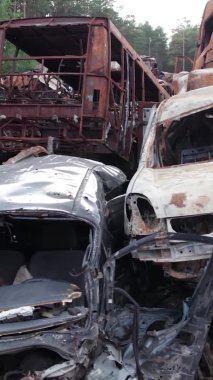 Bu stok dikey video Irpin, Bucha bölgesinde bir kurşun ve yanmış araba dökümü gösteriyor.