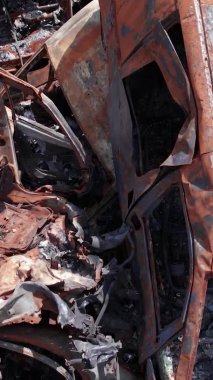 Bu stok dikey video Irpin, Bucha bölgesinde bir kurşun ve yanmış araba dökümü gösteriyor.