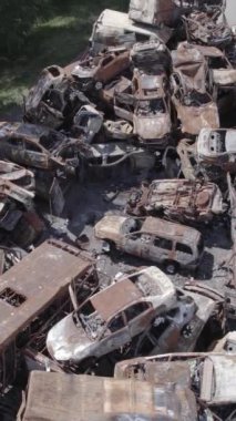 Bu stok dikey video Irpin, Bucha bölgesinde bir kurşun ve yanmış araba dökümü gösteriyor.