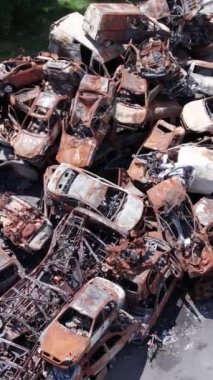 Bu stok dikey video Irpin, Bucha bölgesinde bir kurşun ve yanmış araba dökümü gösteriyor.