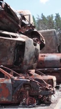 Bu stok dikey video Irpin, Bucha bölgesinde bir kurşun ve yanmış araba dökümü gösteriyor.