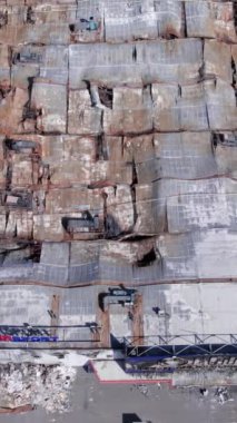 This stock vertical video shows a destroyed building of a shopping center in Bucha