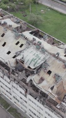Bu borsa dikey videosu Stoyanka, Bucha bölgesinde, Ukrayna 'da, gri, renksiz, düz bir bina gösteriyor.