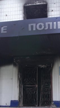 Bu dikey video Ukrayna 'daki savaşın sonucunu gösteriyor. Borodyanka, Kyiv bölgesindeki polis karakolunun yıkılmış ve yanmış binası. Gri, renksiz, düz.