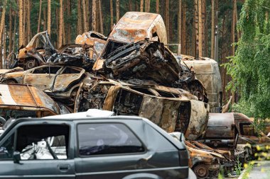 This stock photo shows a dump of shot and burned cars in Irpin, Bucha district clipart