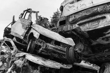 This stock black and white photo shows a dump of shot and burned cars in Irpin, Bucha district, BW