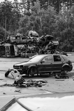 This stock black and white photo shows a dump of shot and burned cars in Irpin, Bucha district, BW