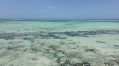 This stock video shows kitesurf near the coast of Zanzibar, Tanzania in 8K resolution