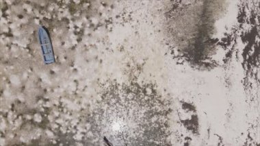 This stock video shows aerial view of low tide in the ocean off the coast of Zanzibar in 8K resolution