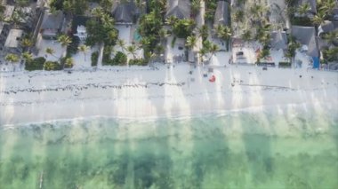 This stock video shows an aerial view of the ocean near the coast of Zanzibar, Tanzania in 8K resolution