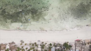 This stock video shows an aerial view of the ocean near the coast of Zanzibar, Tanzania in 8K resolution