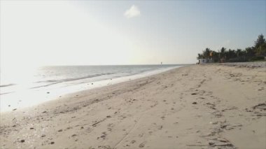 This stock video shows an aerial view of the ocean near the coast of Zanzibar, Tanzania in 8K resolution