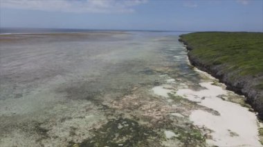 This stock video shows an aerial view of the ocean near the coast of Zanzibar, Tanzania in 8K resolution