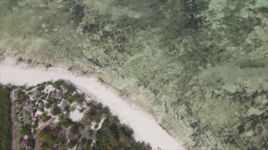 This stock video shows an aerial view of the ocean near the coast of Zanzibar, Tanzania in 8K resolution