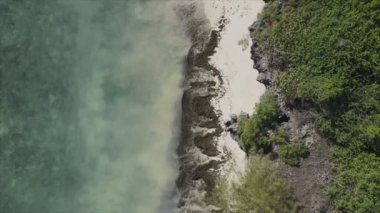 This stock video shows an aerial view of the ocean near the coast of Zanzibar, Tanzania in 8K resolution