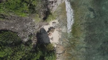 This stock video shows an aerial view of the ocean near the coast of Zanzibar, Tanzania in 8K resolution