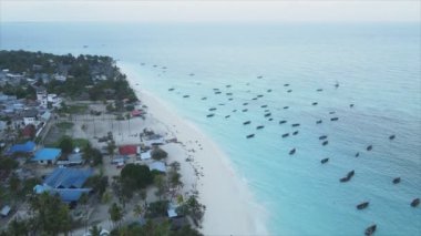 This stock video shows an aerial view of the ocean near the coast of Zanzibar, Tanzania in 8K resolution