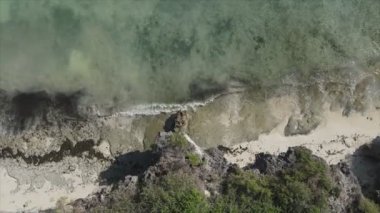 This stock video shows an aerial view of the ocean near the coast of Zanzibar, Tanzania in 8K resolution