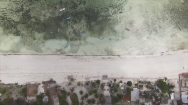 This stock video shows an aerial view of the ocean near the coast of Zanzibar, Tanzania in 8K resolution