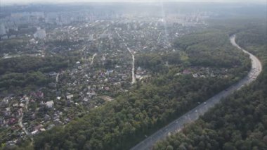 This stock footage shows an aerial view of the border of a forest and a big city, Kyiv, Ukraine in 8K resolution