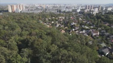 This stock footage shows an aerial view of the border of a forest and a big city, Kyiv, Ukraine in 8K resolution