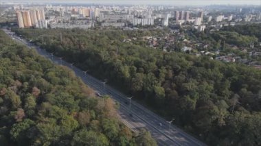 This stock footage shows an aerial view of the border of a forest and a big city, Kyiv, Ukraine in 8K resolution