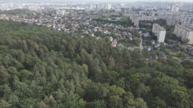 This stock footage shows an aerial view of the border of a forest and a big city, Kyiv, Ukraine in 8K resolution