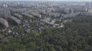 This stock footage shows an aerial view of the border of a forest and a big city, Kyiv, Ukraine in 8K resolution