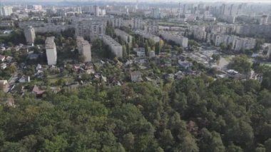 This stock footage shows an aerial view of the border of a forest and a big city, Kyiv, Ukraine in 8K resolution