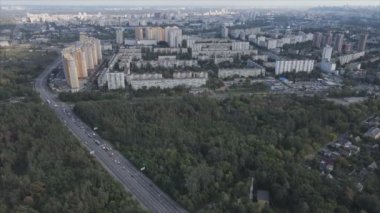 This stock footage shows an aerial view of the border of a forest and a big city, Kyiv, Ukraine in 8K resolution