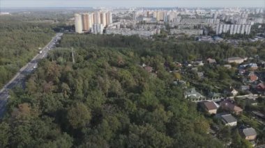 This stock footage shows an aerial view of the border of a forest and a big city, Kyiv, Ukraine in 8K resolution