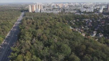 This stock footage shows an aerial view of the border of a forest and a big city, Kyiv, Ukraine in 8K resolution