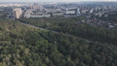 This stock footage shows an aerial view of the border of a forest and a big city, Kyiv, Ukraine in 8K resolution