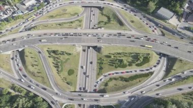 This stock footage shows an aerial view of a traffic intersection with cars driving along it in Kyiv, Ukraine in 8K resolution