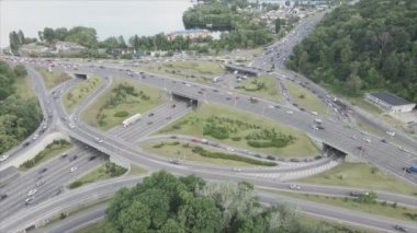 This stock footage shows an aerial view of a traffic intersection with cars driving along it in Kyiv, Ukraine in 8K resolution