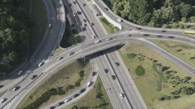 This stock footage shows an aerial view of a traffic intersection with cars driving along it in Kyiv, Ukraine in 8K resolution