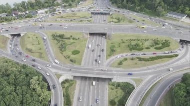 This stock footage shows an aerial view of a traffic intersection with cars driving along it in Kyiv, Ukraine in 8K resolution