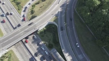 This stock footage shows an aerial view of a traffic intersection with cars driving along it in Kyiv, Ukraine in 8K resolution