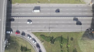 This stock footage shows an aerial view of a traffic intersection with cars driving along it in Kyiv, Ukraine in 8K resolution